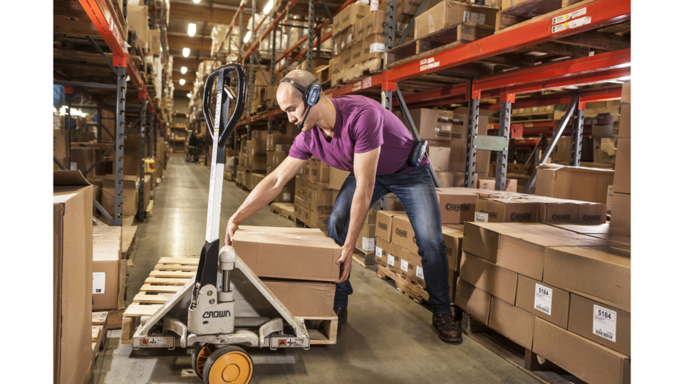 Man lifting in warehouse